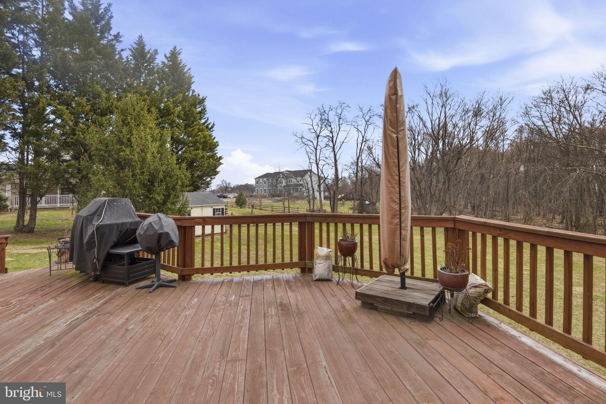 15611 Riding Stable Road Laurel, MD 20707 - Photo 73 of 86 a view of a roof deck with wooden floor and fence