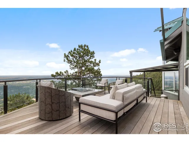 a view of roof deck with couches and wooden floor