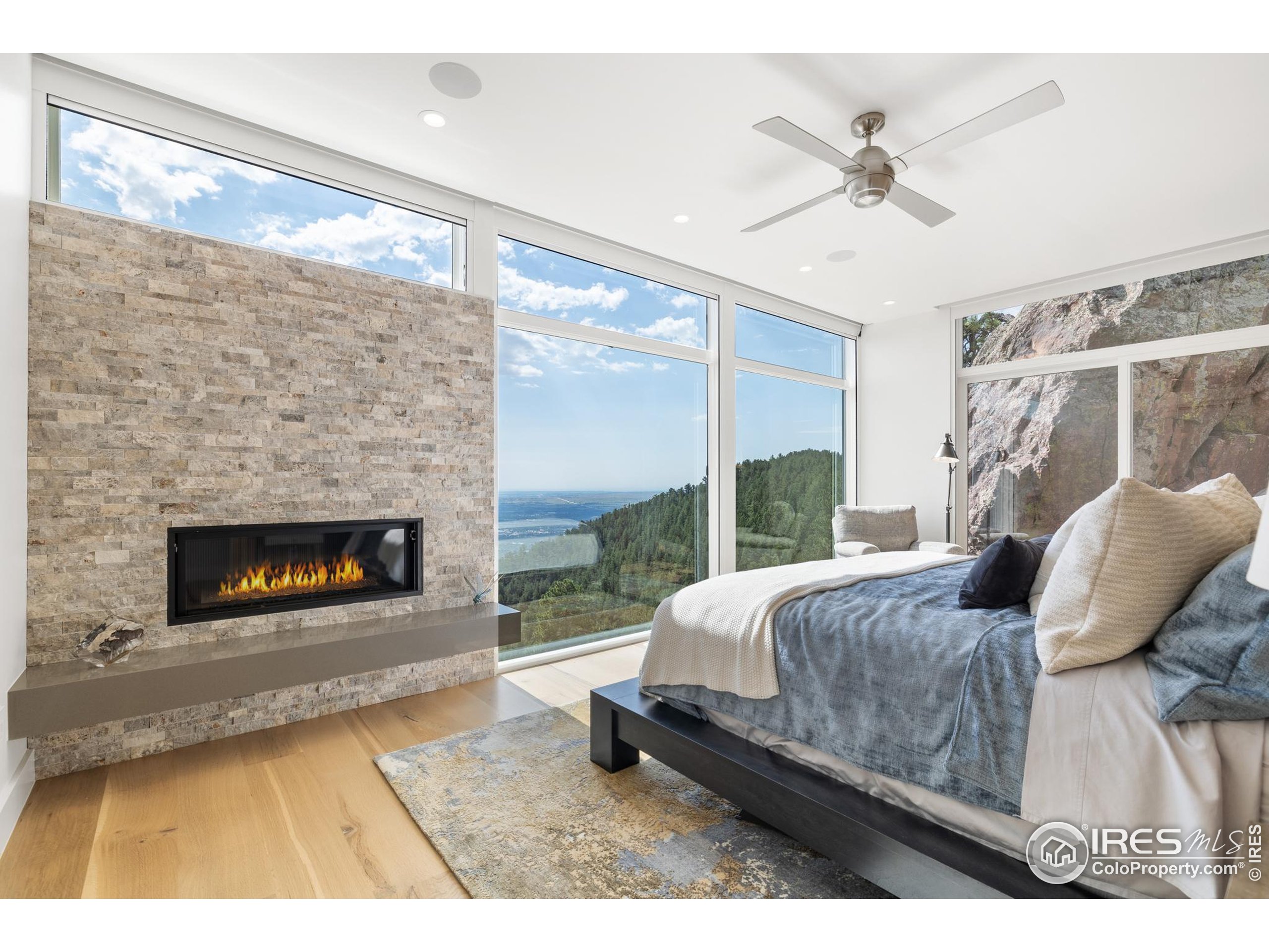 1145 Timber Lane Boulder, CO 80304 - Photo 12 of 40 a living room with a bed furniture a fireplace and a large window