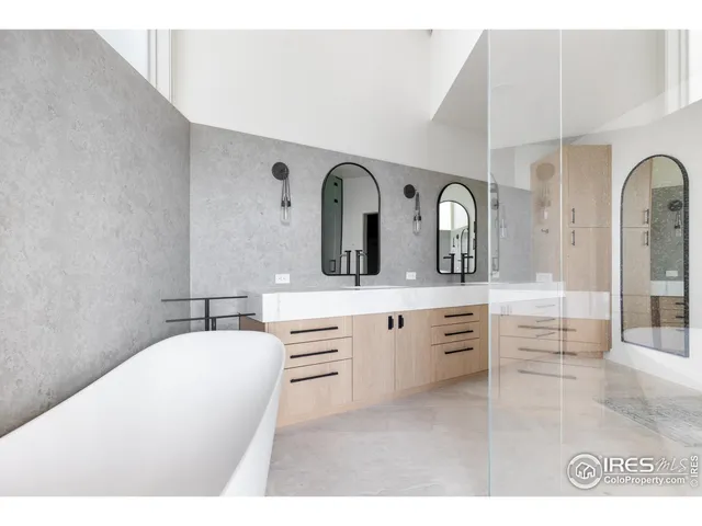 a spacious bathroom with a double vanity sink and a mirror