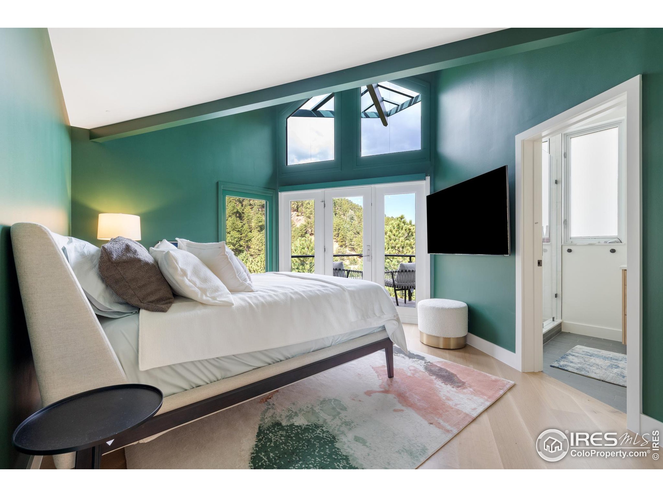 1145 Timber Lane Boulder, CO 80304 - Photo 18 of 40 a bedroom with a bed a mirror on the dresser and a large window