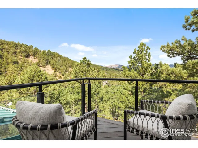 a view of a balcony with wooden floor and outdoor seating