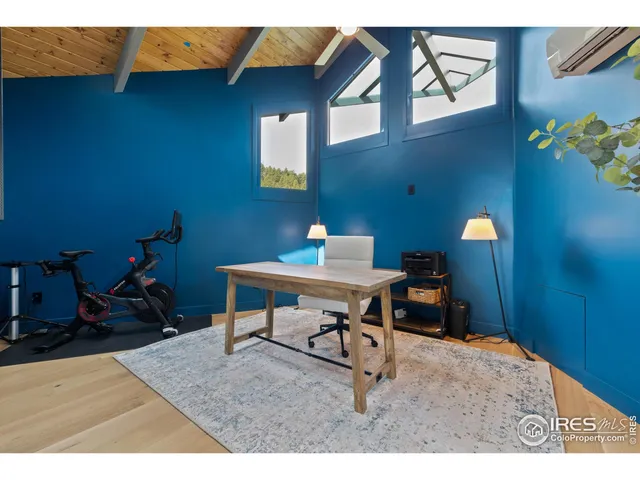 a work room with furniture and wooden floor
