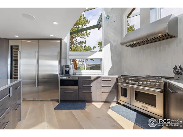 a kitchen with stainless steel appliances granite countertop a stove a refrigerator and a microwave