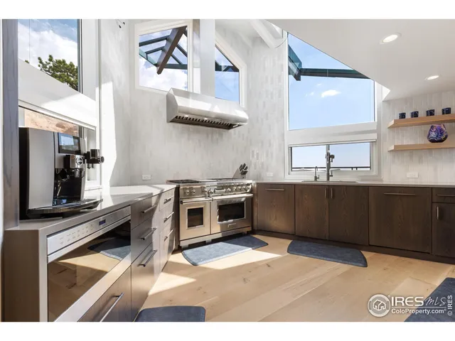 a kitchen with stainless steel appliances kitchen island granite countertop a stove a sink and a microwave