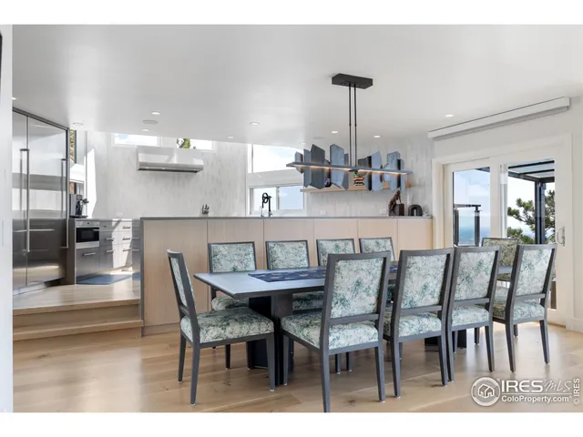 a dining room with furniture and wooden floor