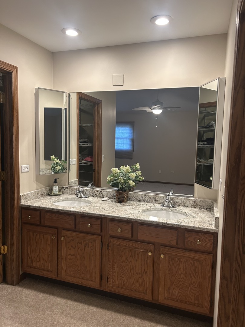 527 Springwood Lane Bolingbrook, IL 60440 - Photo 26 of 35 a bathroom with double vanity sinks and a large mirror