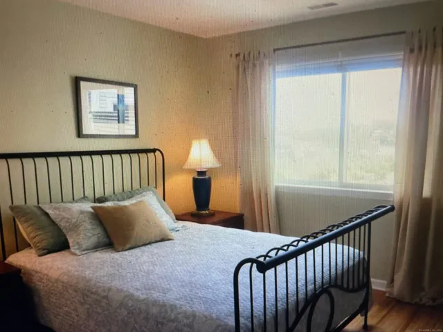 a bed sitting in a bedroom next to a window