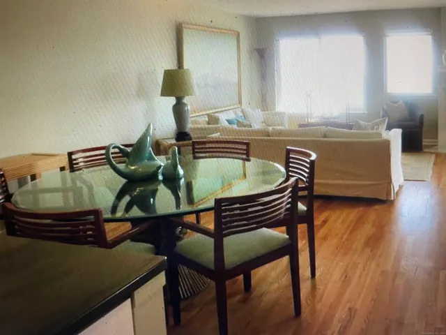 a dining room with furniture and wooden floor