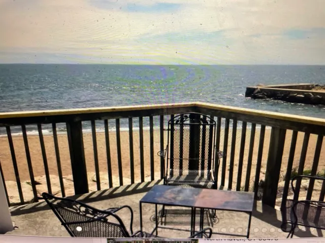 a view of a balcony with wooden chairs