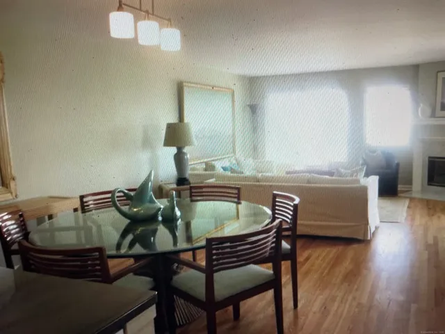 a dining room with furniture and wooden floor