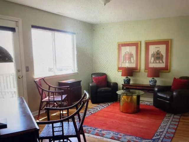 a living room with furniture a rug and a window