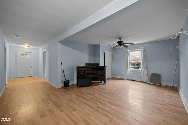 a view of a livingroom with a hardwood floor and a ceiling fan