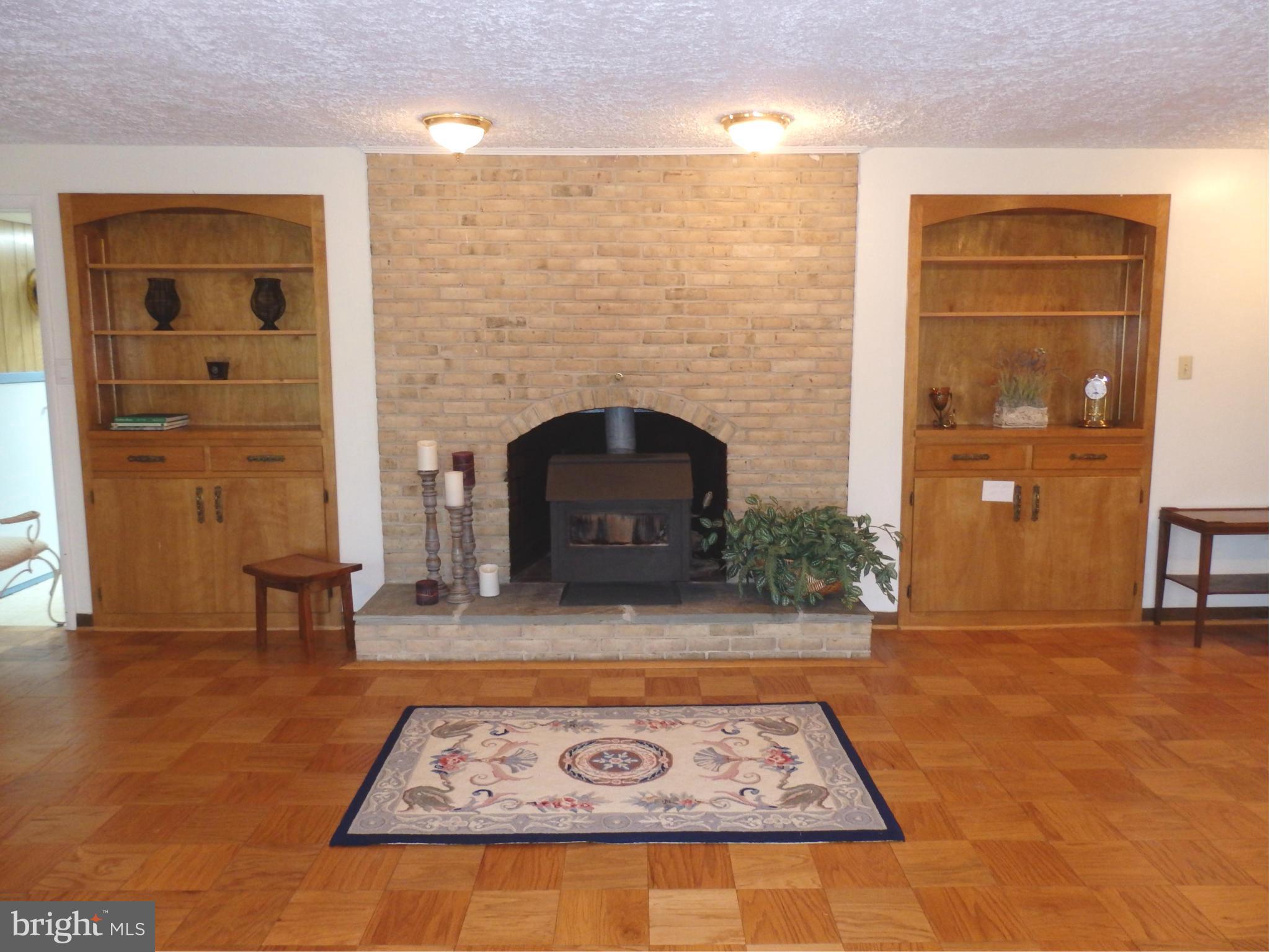 5512 Woodlyn Road Frederick, MD 21703 - Photo 24 of 30 Family Room has woodstove insert and built-ins.