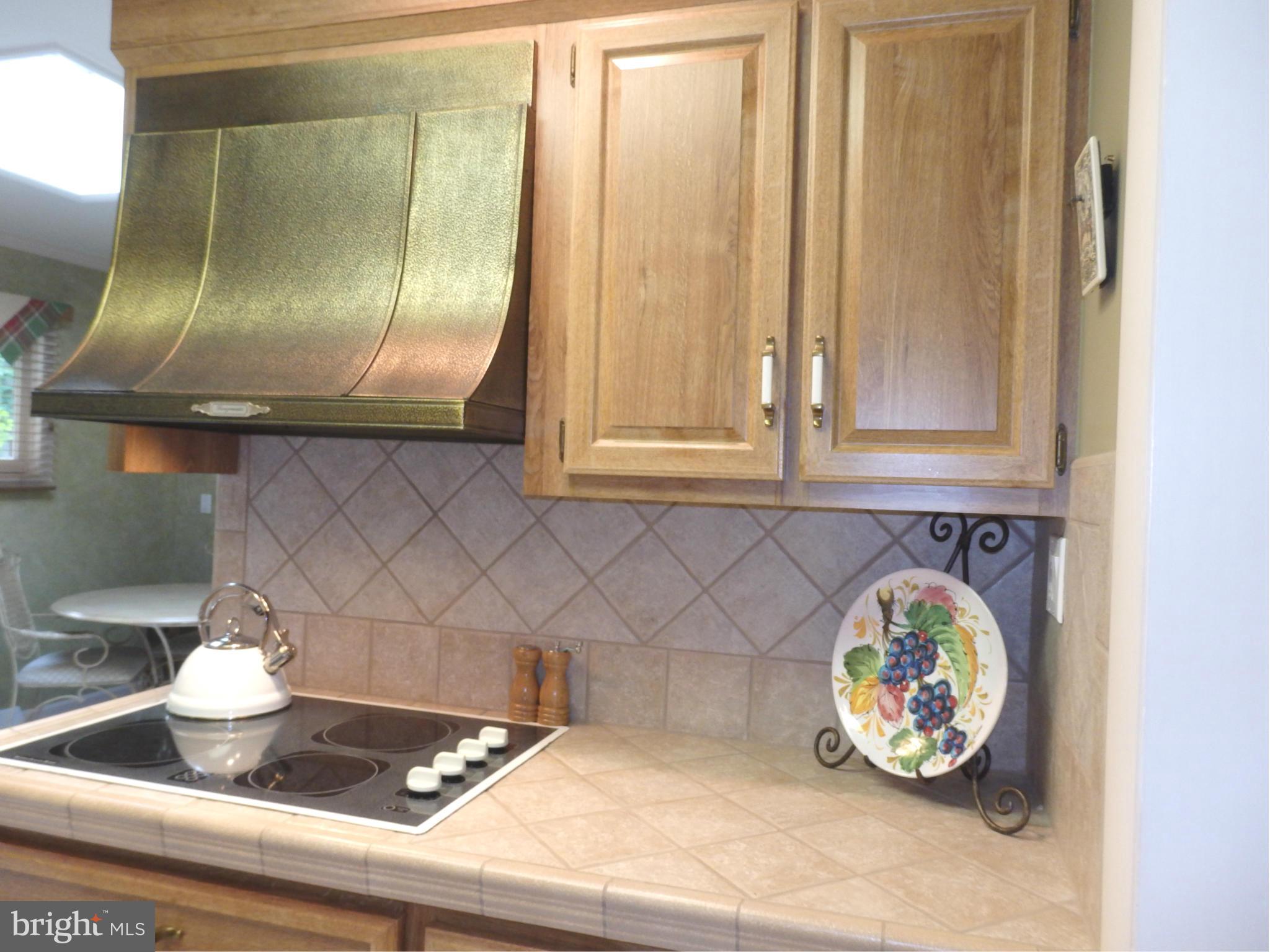 5512 Woodlyn Road Frederick, MD 21703 - Photo 6 of 30 Kitchen has cooktop and tile counter.