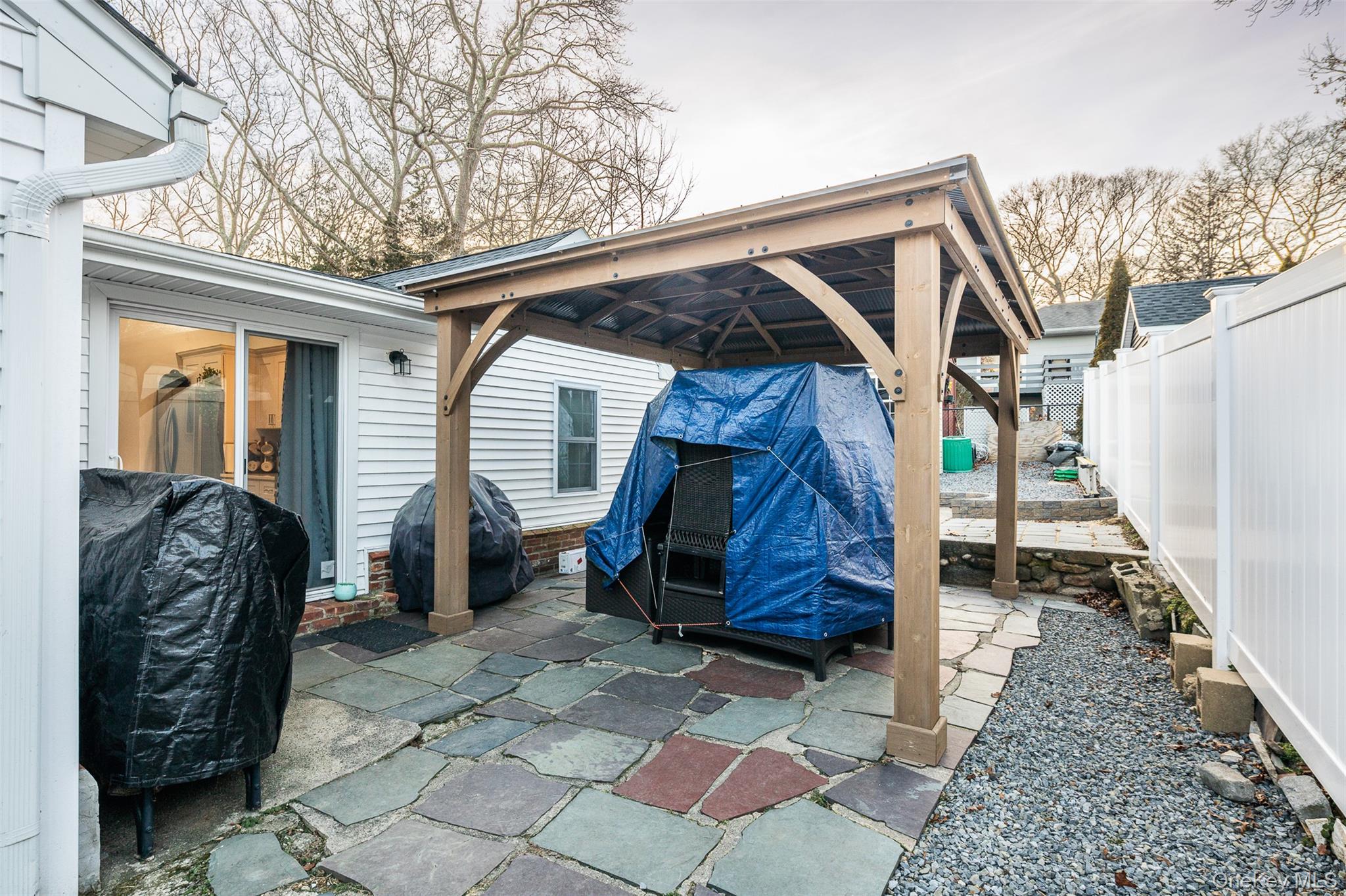 3 Cedar Road Sound Beach, NY 11789 - Photo 13 of 14 a backyard of a house with barbeque oven and glass windows