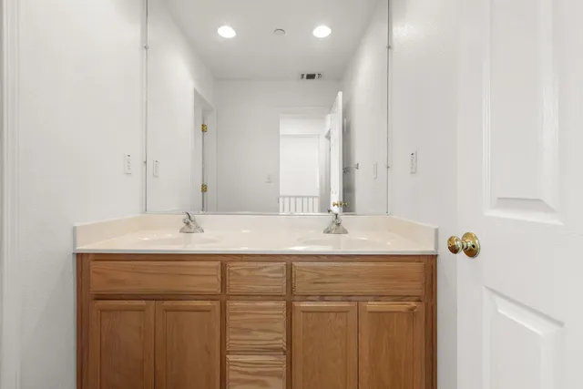 a bathroom with a sink a toilet and a window