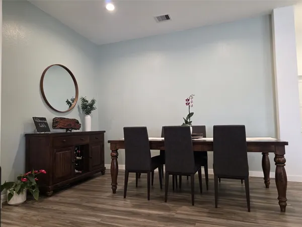a view of a dining room with furniture and wooden floor