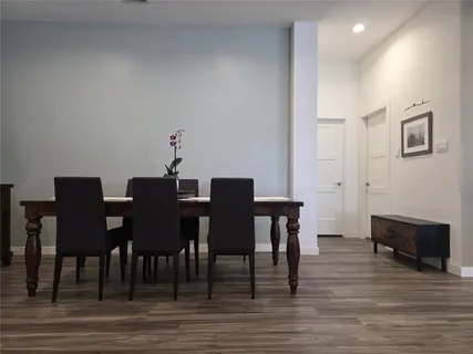 a view of kitchen dining table chairs microwave and cabinets
