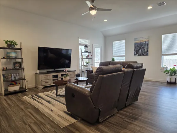 a kitchen with a sink a refrigerator and a stove top oven