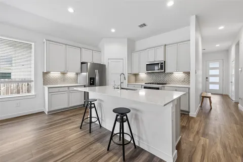 a kitchen with a sink a refrigerator and window
