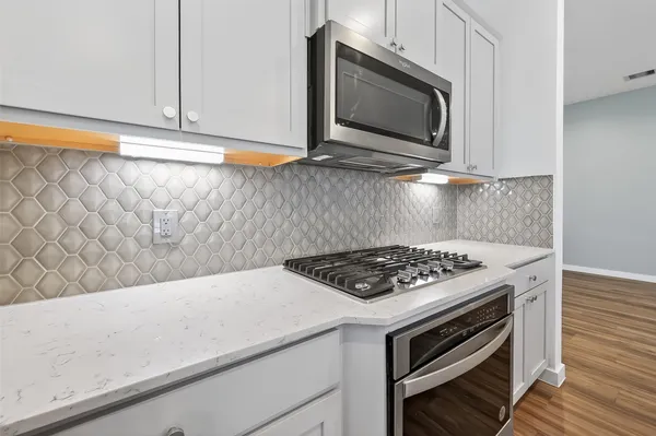 a kitchen with a stove and a microwave