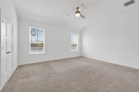 an empty room with windows and closet