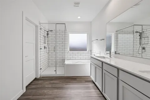 a bathroom with a shower sink and mirror
