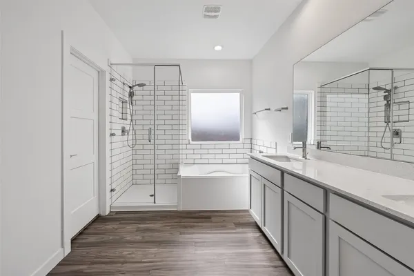 a bathroom with a shower sink and mirror