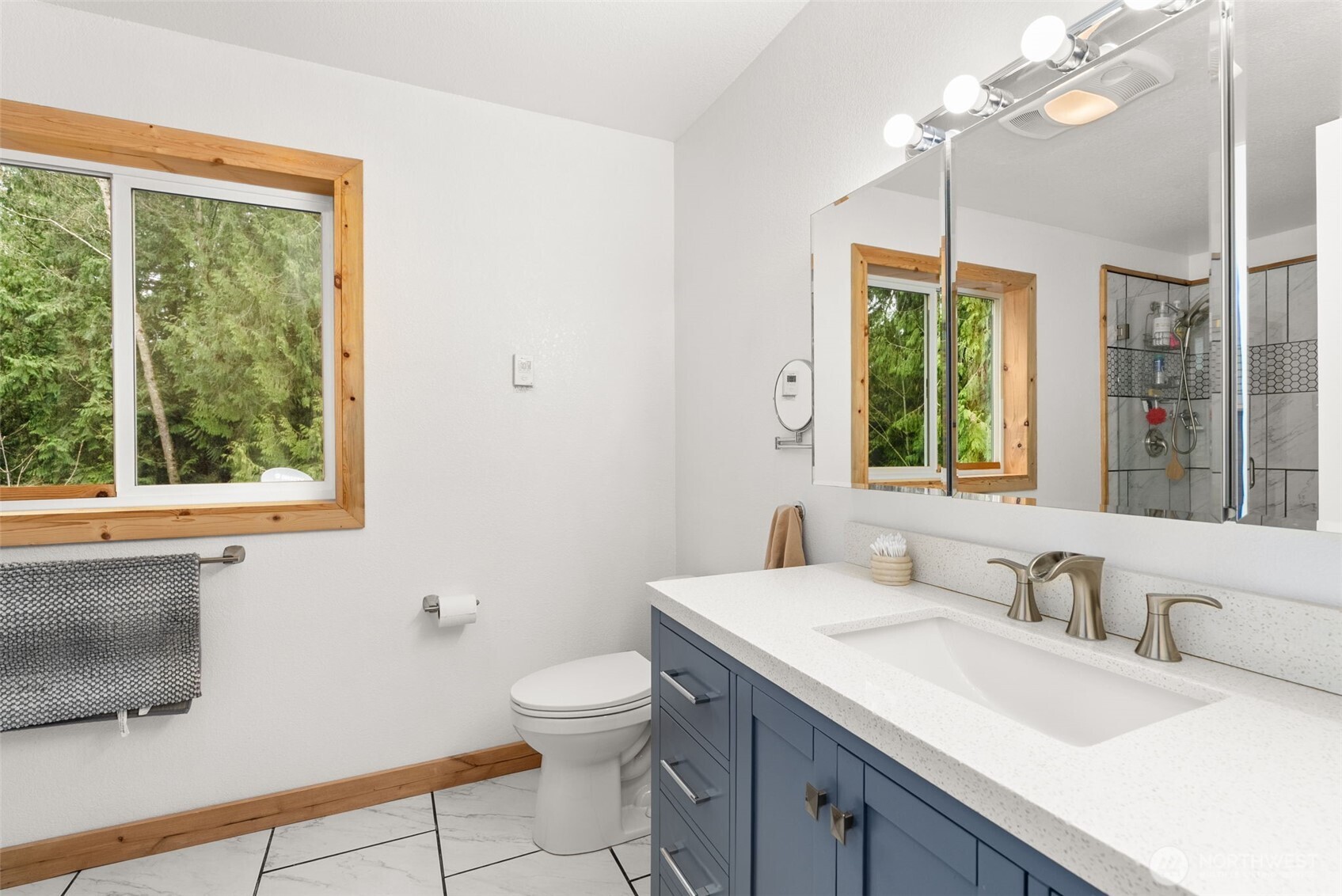 2434 Salzer Valley Road Centralia, WA 98531 - Photo 24 of 39 a bathroom with a granite countertop sink a large mirror a toilet and a window