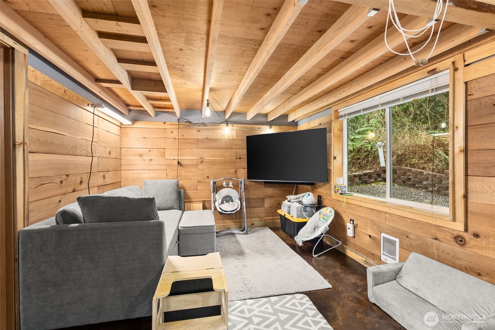 2434 Salzer Valley Road Centralia, WA 98531 - Photo 30 of 39 a living room with furniture a flat screen tv and a floor to ceiling window