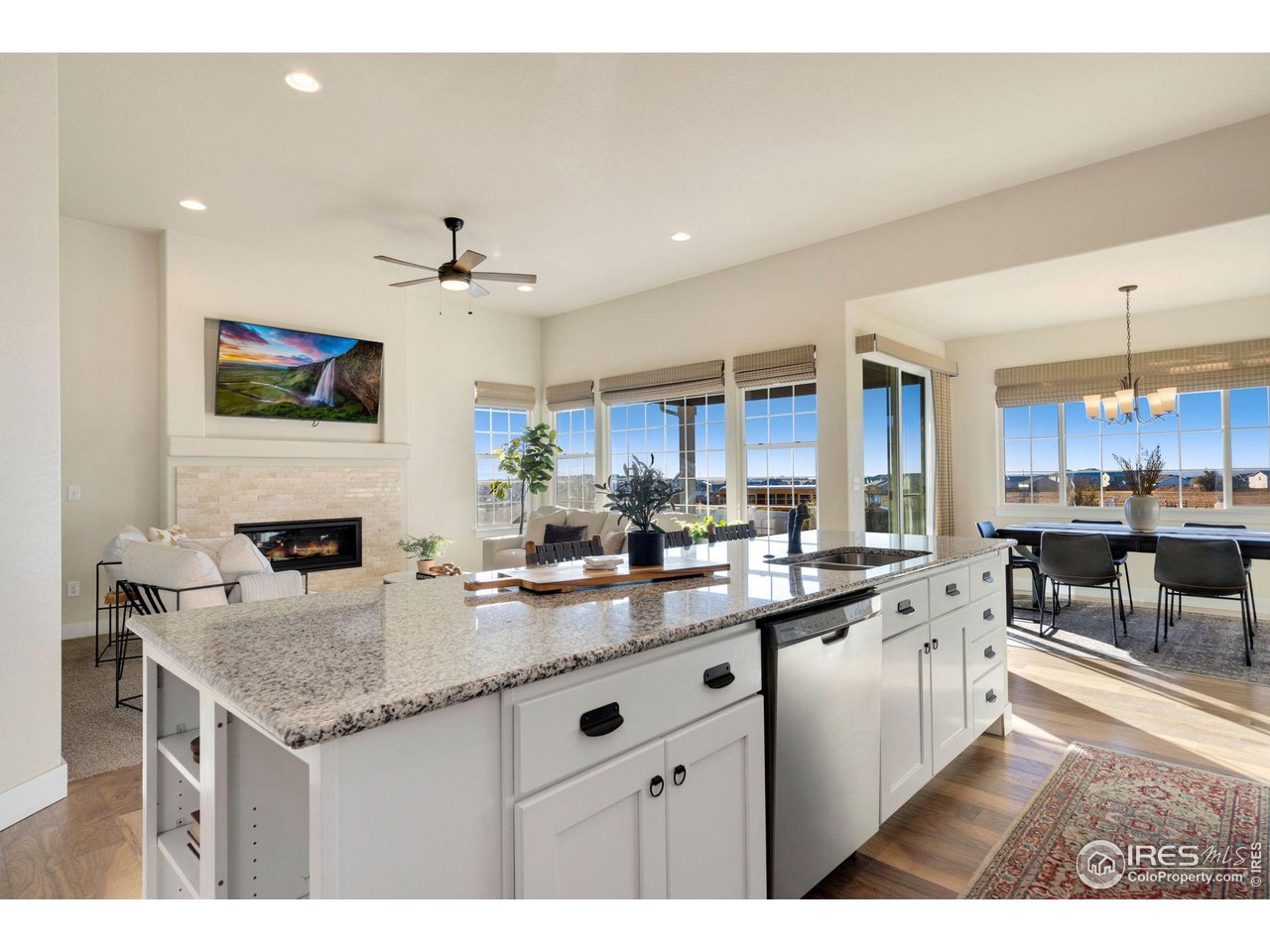 985 Mount Andrew Drive Severance, CO 80550 - Photo 12 of 25 a kitchen with granite countertop a sink a counter top space appliances and cabinets