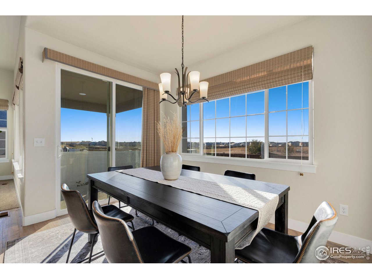 985 Mount Andrew Drive Severance, CO 80550 - Photo 13 of 25 a kitchen with a table chairs a sink dishwasher window and cabinets