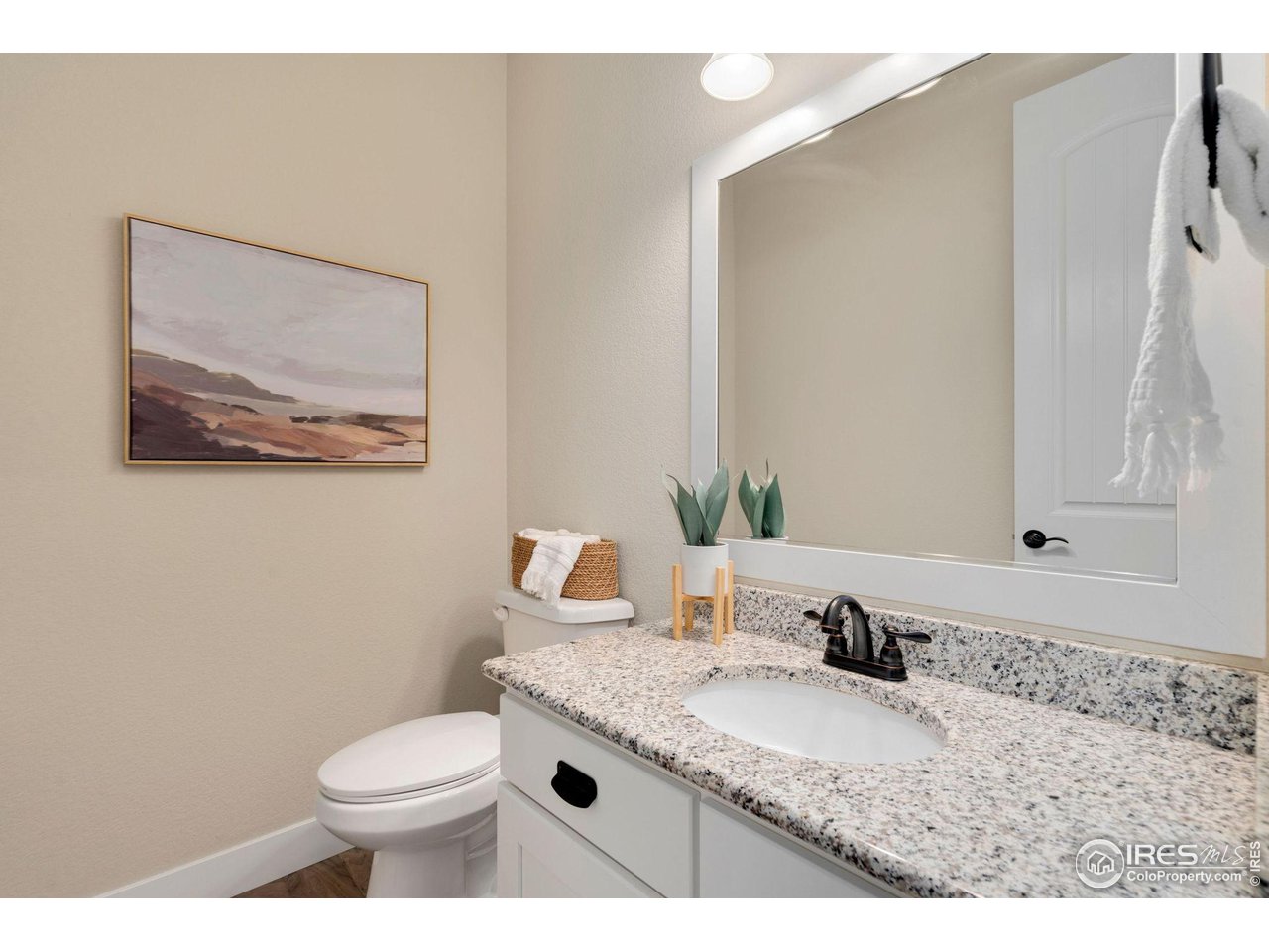 985 Mount Andrew Drive Severance, CO 80550 - Photo 15 of 25 a bathroom with a granite countertop sink mirror vanity and toilet