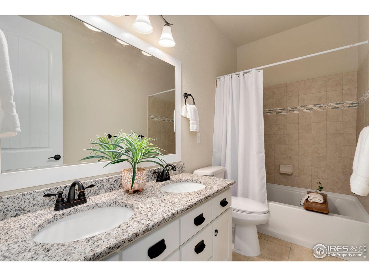 985 Mount Andrew Drive Severance, CO 80550 - Photo 21 of 25 a bathroom with a granite countertop sink and a mirror