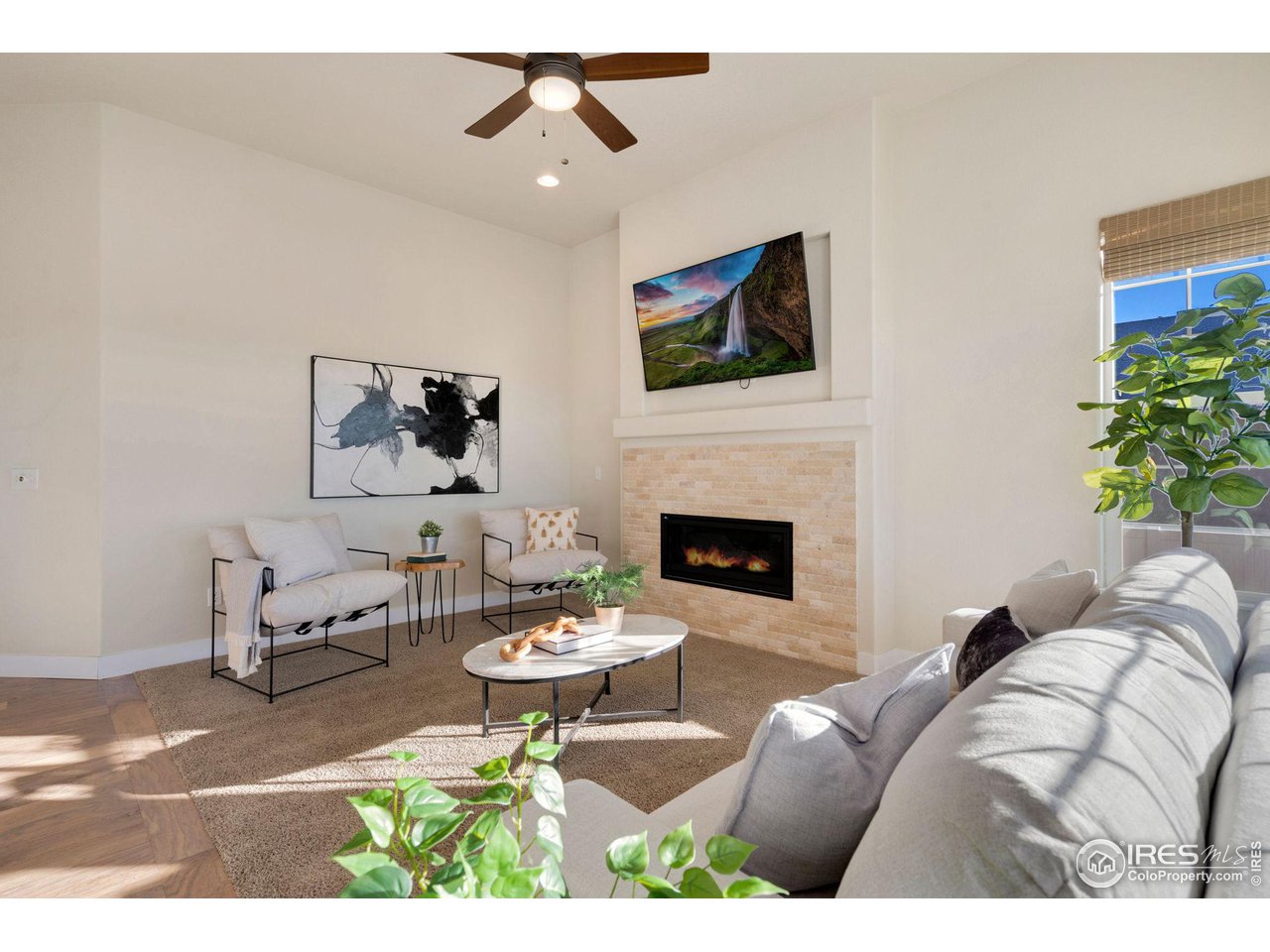 985 Mount Andrew Drive Severance, CO 80550 - Photo 7 of 25 a living room with furniture a flat screen tv and a fireplace