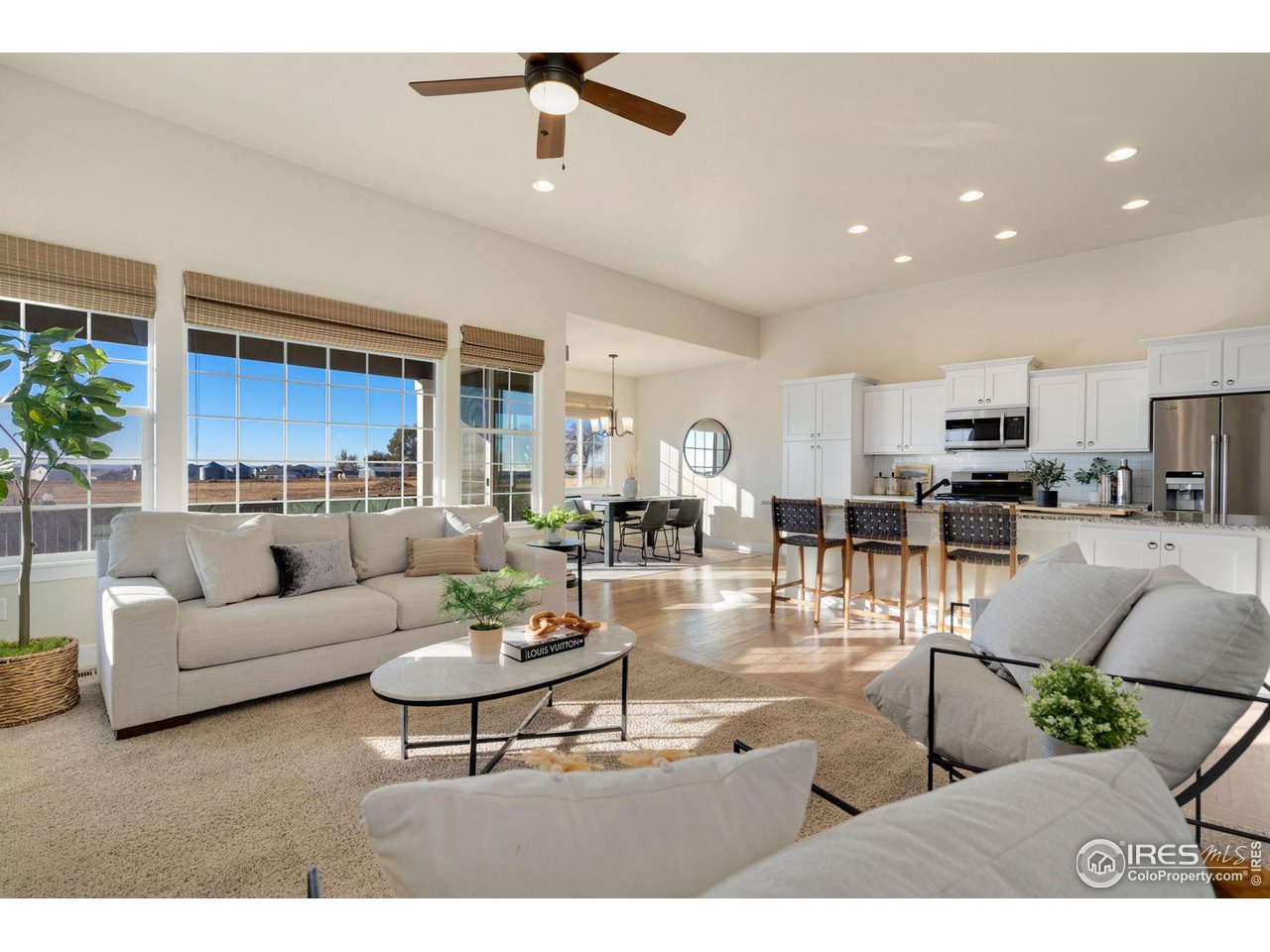 985 Mount Andrew Drive Severance, CO 80550 - Photo 8 of 25 a living room with furniture kitchen view and a chandelier