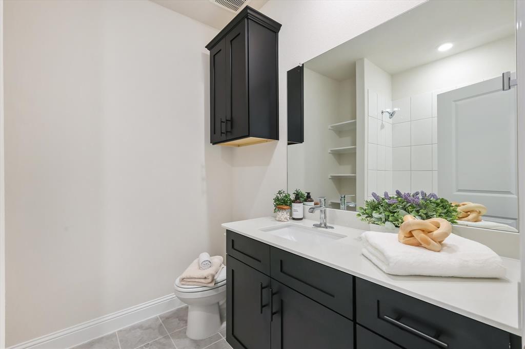 4518 Community Court Plano, TX 75024 - Photo 22 of 32 a bathroom with a sink a toilet and mirror