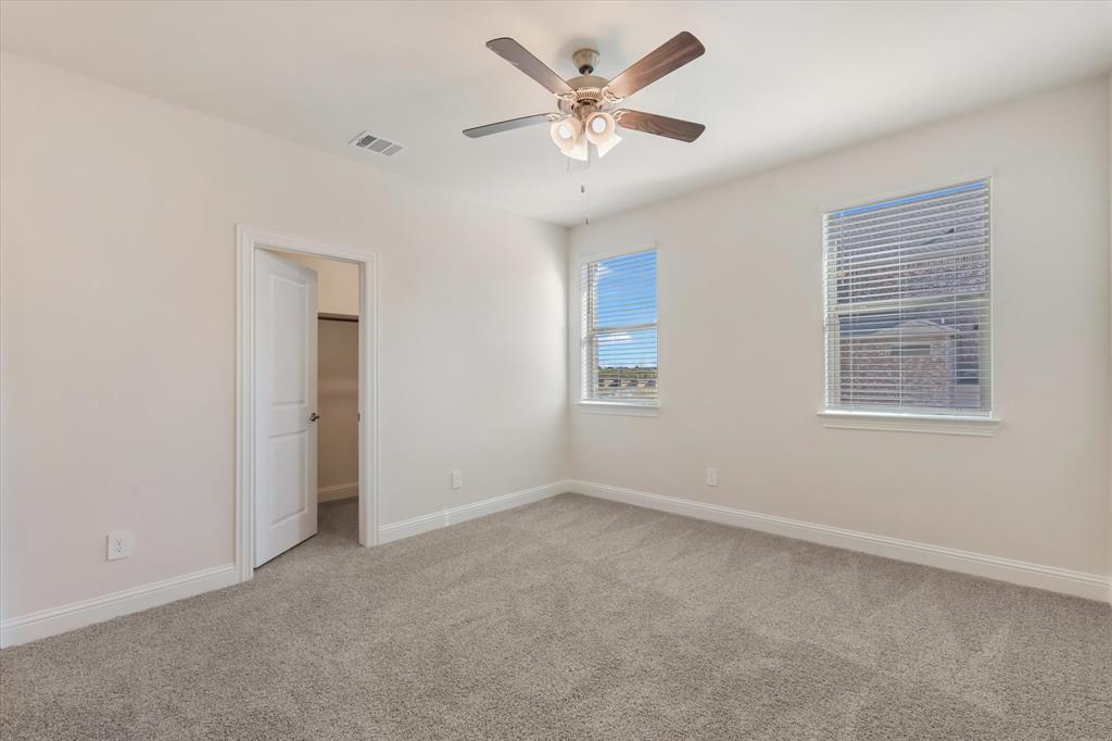 4518 Community Court Plano, TX 75024 - Photo 24 of 32 an empty room with windows and fan