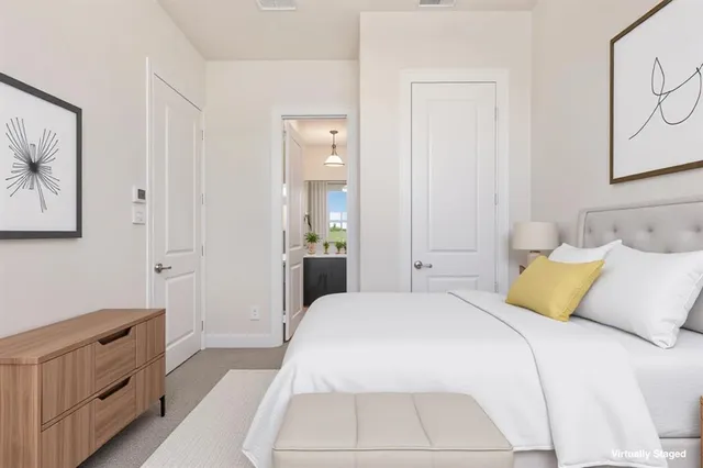 a view of an empty room with closet and a bathroom