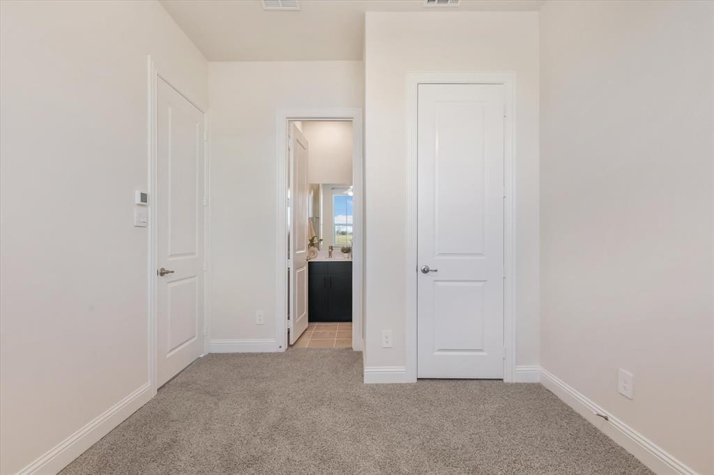 4518 Community Court Plano, TX 75024 - Photo 27 of 32 a view of an empty room with closet and a bathroom