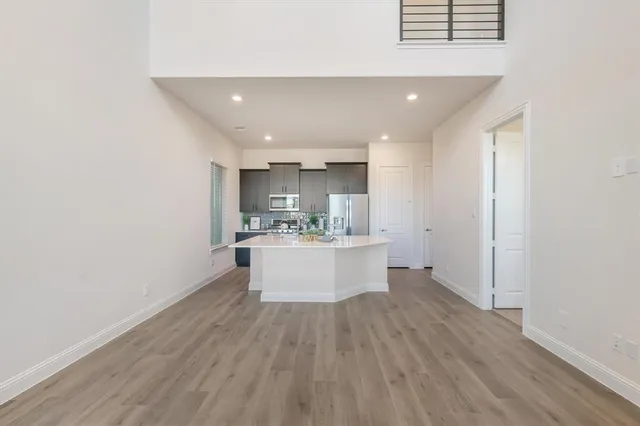 a kitchen with kitchen island a white counter top space and refrigerator