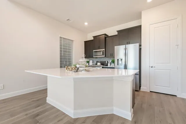 a kitchen with stainless steel appliances granite countertop a sink and a stove