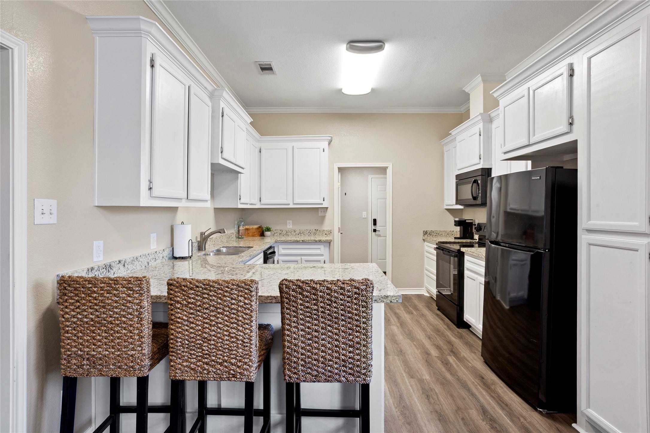 427 West 1st Street Freeport, TX 77541 - Photo 5 of 21 a kitchen with granite countertop a refrigerator stove top oven and sink