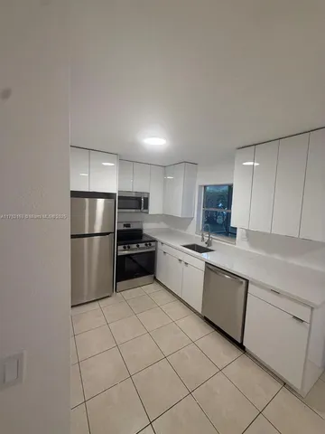 a kitchen with cabinets and stainless steel appliances