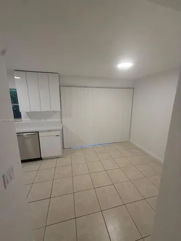 a view of a kitchen with white cabinets