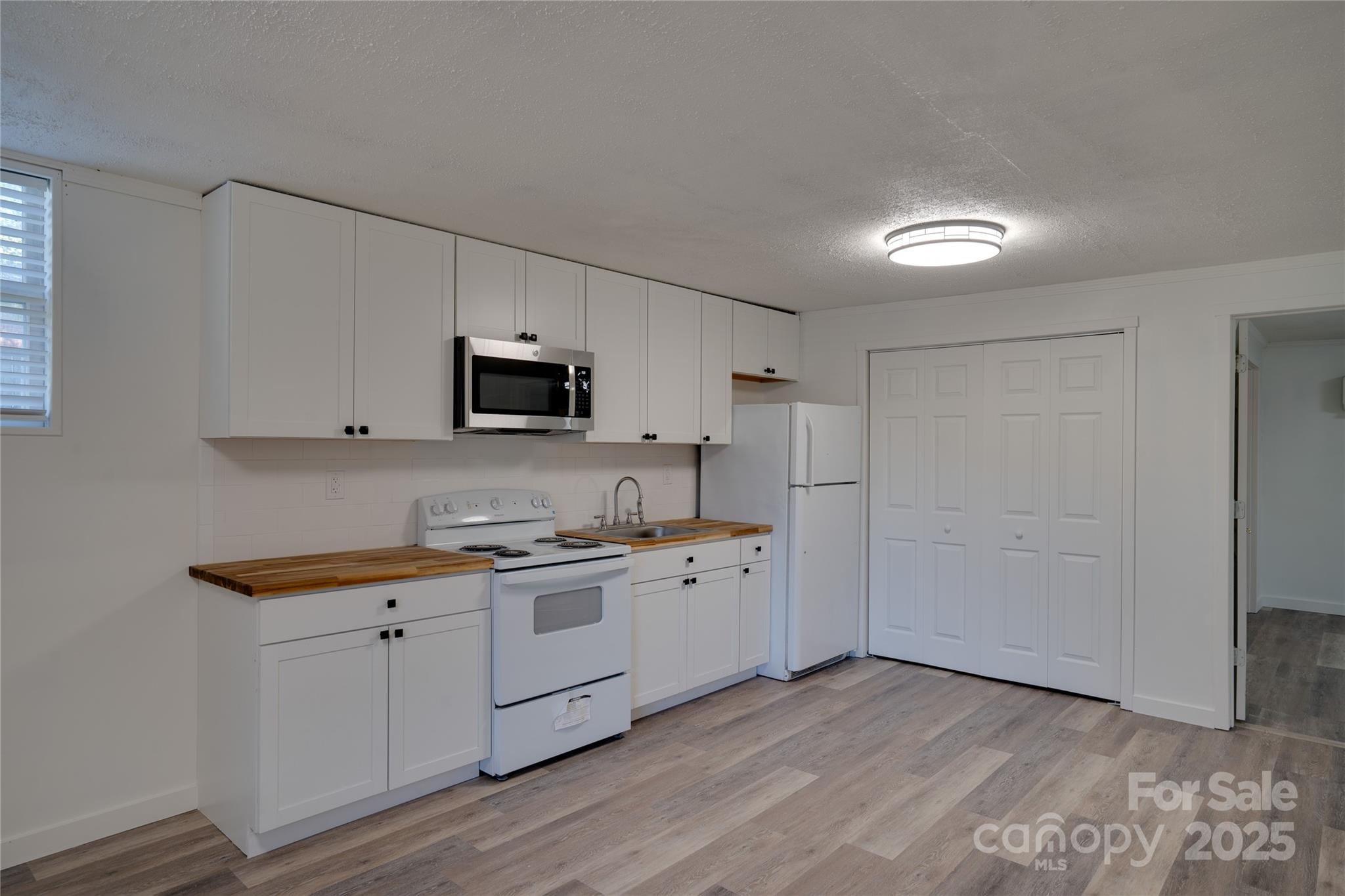 a kitchen with a sink a stove and cabinets