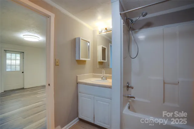 a bathroom with a shower and a sink