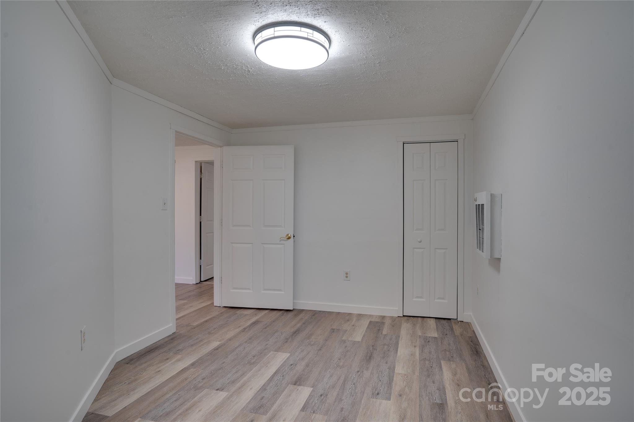 401 Little Street Lincolnton, NC 28092 - Photo 13 of 17 an empty room with wooden floor and windows
