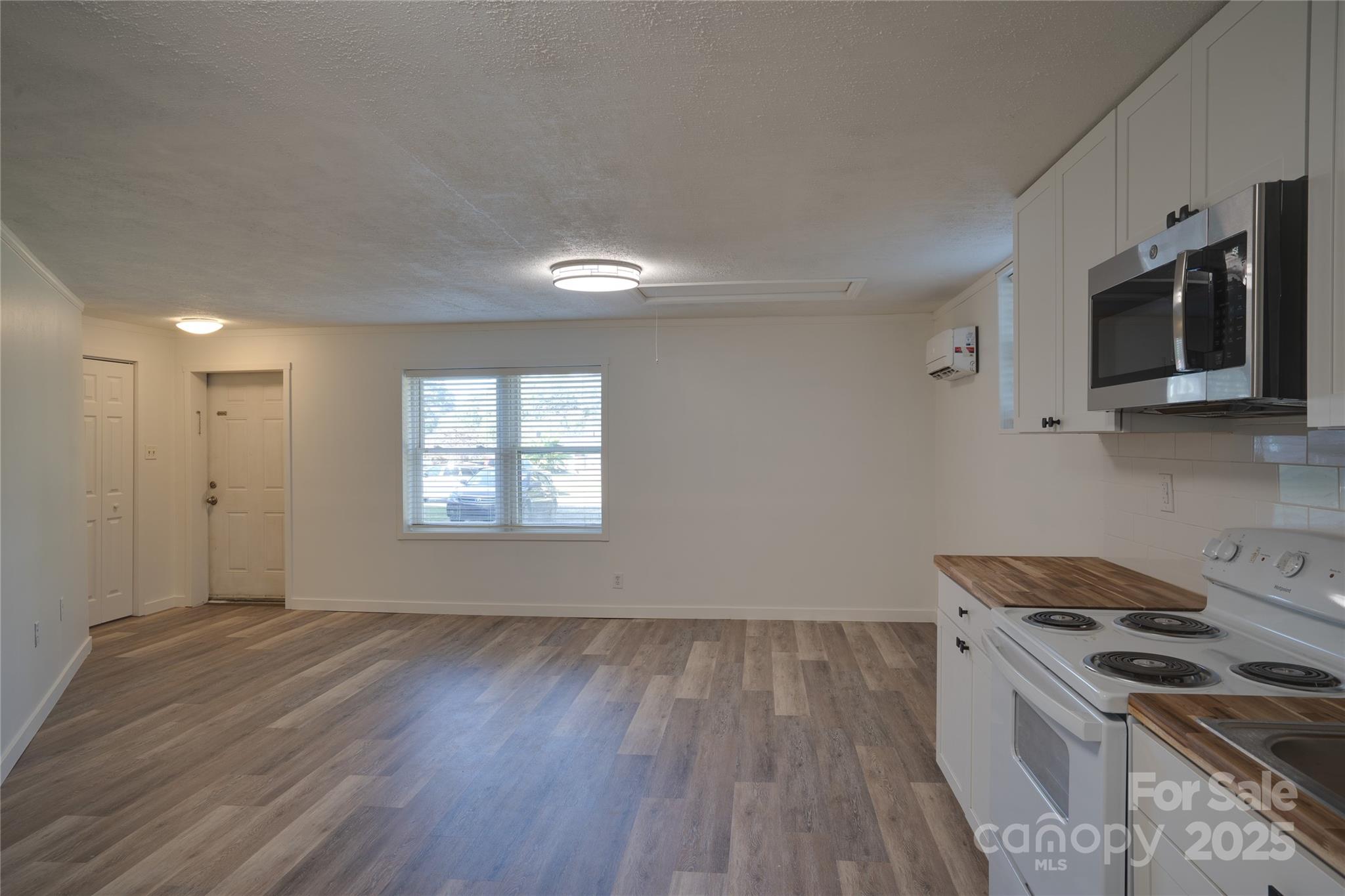 401 Little Street Lincolnton, NC 28092 - Photo 4 of 17 a kitchen that has a sink wooden floor and stainless steel appliances